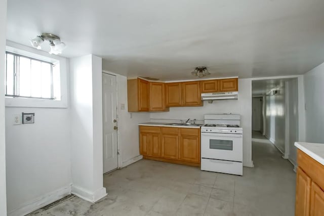 kitchen with sink and white gas stove