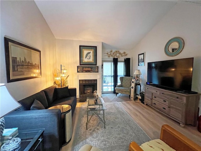 living room with lofted ceiling and light hardwood / wood-style floors