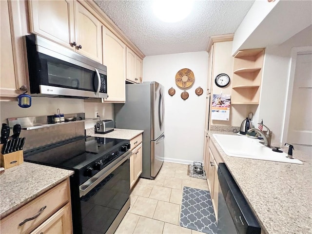 kitchen with sink, black appliances, a textured ceiling, and light brown cabinets