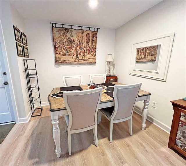 dining space with light hardwood / wood-style flooring