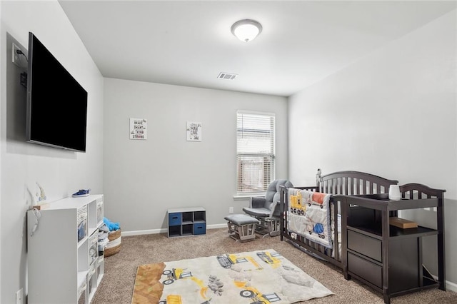 bedroom featuring a crib and carpet