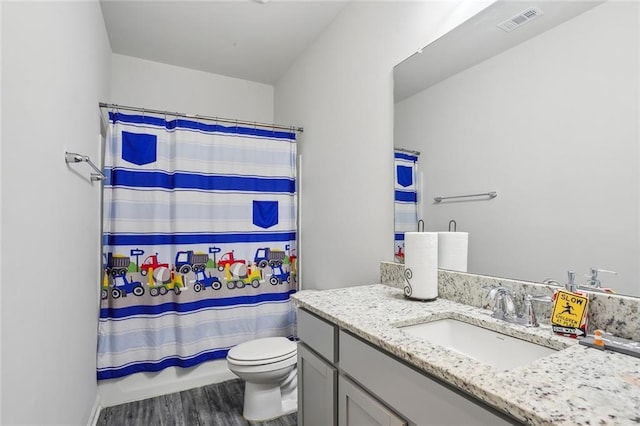 bathroom featuring vanity, wood-type flooring, toilet, and a shower with shower curtain