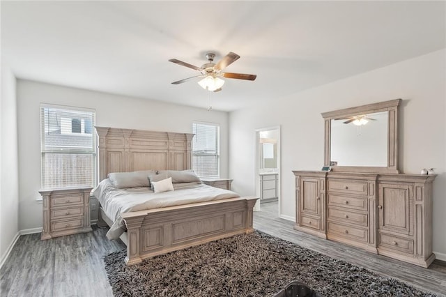 bedroom with hardwood / wood-style flooring, ensuite bath, and ceiling fan