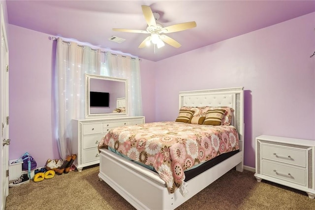 bedroom featuring dark colored carpet and ceiling fan