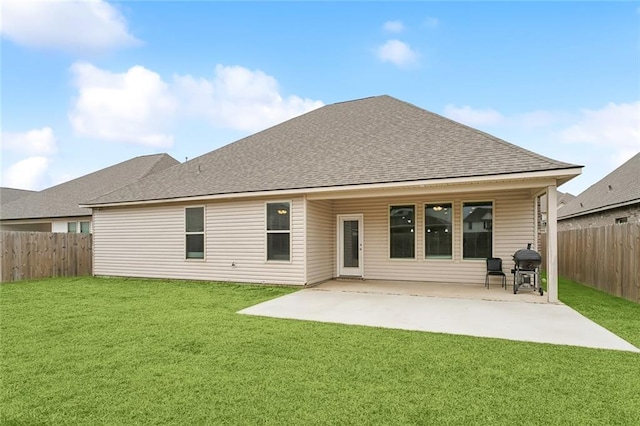 back of property with a patio and a lawn