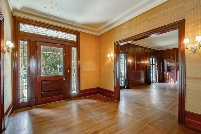 foyer with crown molding and hardwood / wood-style floors