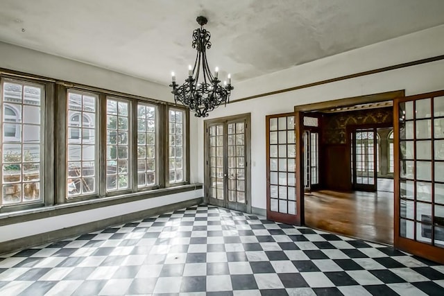 interior space featuring a notable chandelier and french doors