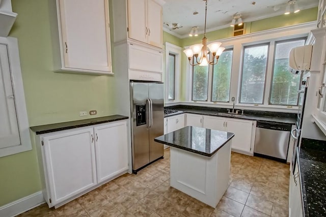 kitchen featuring sink, white cabinetry, hanging light fixtures, appliances with stainless steel finishes, and a kitchen island