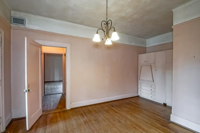 interior space featuring wood-type flooring and a notable chandelier