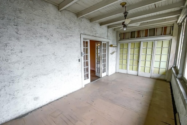 unfurnished sunroom featuring french doors, ceiling fan, and beam ceiling