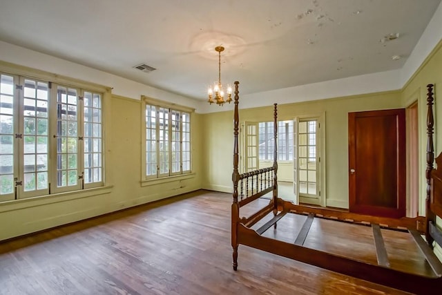 interior space featuring an inviting chandelier, plenty of natural light, and light hardwood / wood-style flooring