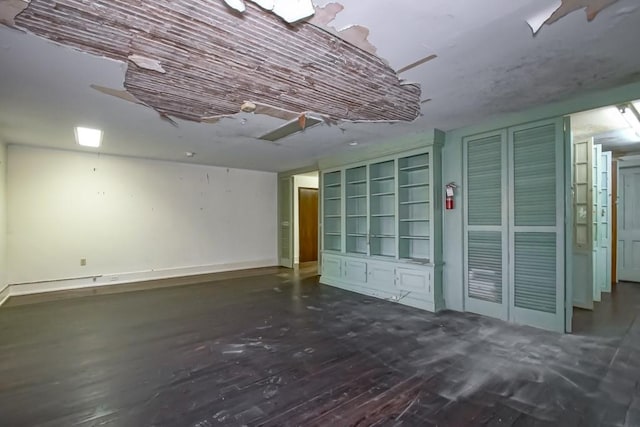 unfurnished room with dark wood-type flooring