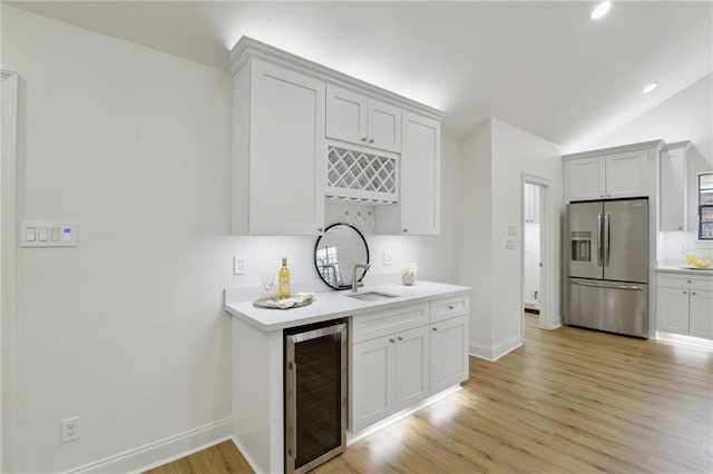 kitchen featuring stainless steel refrigerator with ice dispenser, white cabinetry, and wine cooler