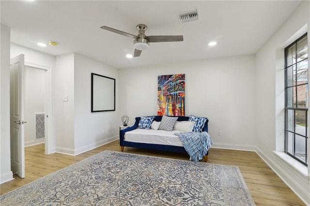 living area with light hardwood / wood-style flooring and ceiling fan