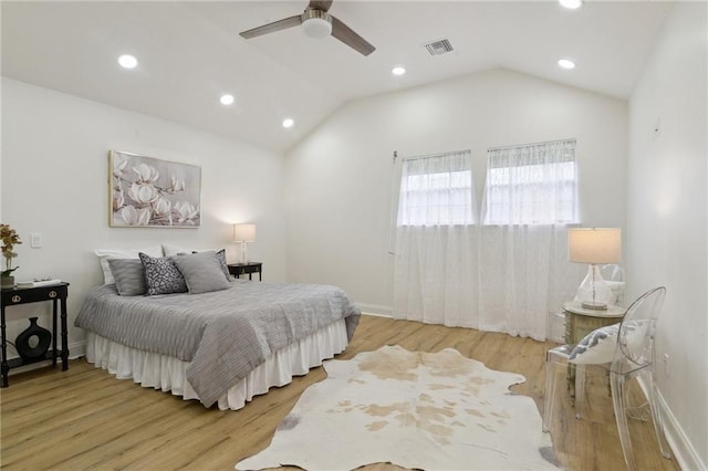 bedroom featuring ceiling fan, lofted ceiling, and light wood-type flooring