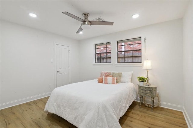 bedroom with ceiling fan and hardwood / wood-style floors