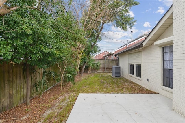 view of yard with a patio and central air condition unit