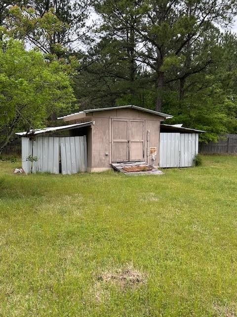 view of outbuilding featuring a lawn