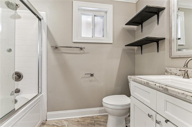 full bathroom with enclosed tub / shower combo, vanity, and toilet