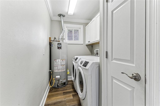 laundry area with washing machine and clothes dryer, gas water heater, cabinets, ornamental molding, and dark hardwood / wood-style flooring