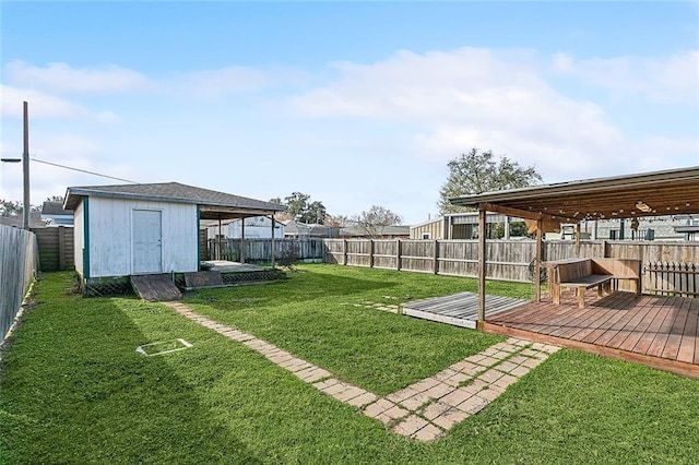 view of yard featuring a wooden deck and a shed