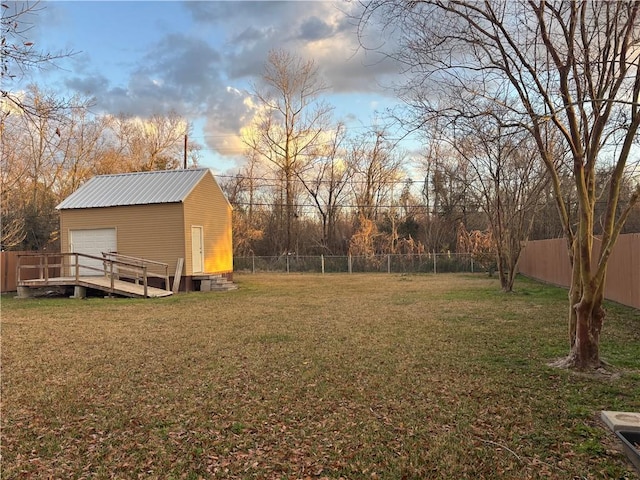 yard at dusk with an outbuilding and a garage