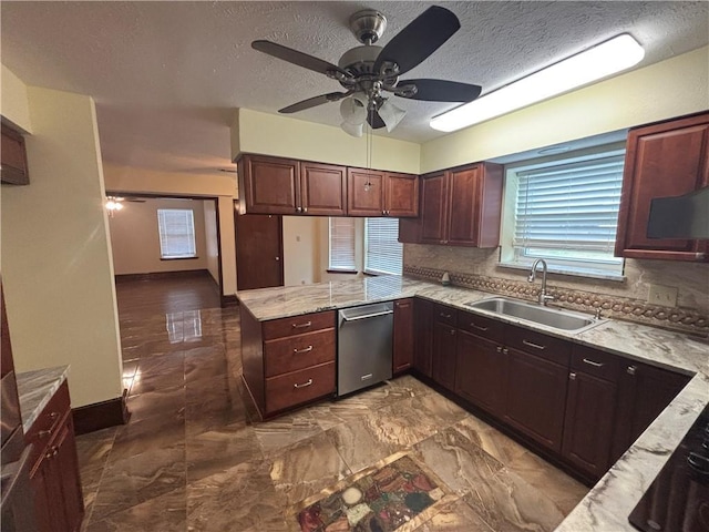 kitchen featuring tasteful backsplash, dishwasher, sink, ceiling fan, and kitchen peninsula