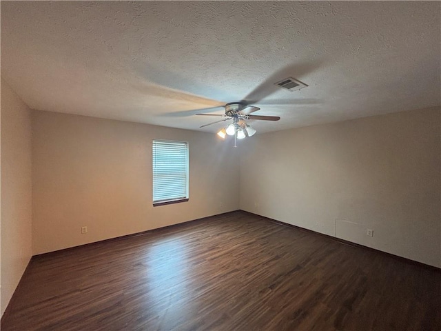 unfurnished room featuring dark wood-type flooring, ceiling fan, and a textured ceiling