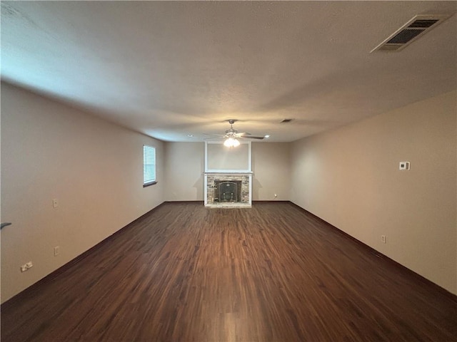 unfurnished living room featuring ceiling fan and dark hardwood / wood-style flooring