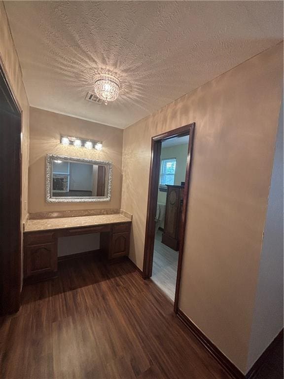 bathroom featuring vanity, hardwood / wood-style floors, and a textured ceiling