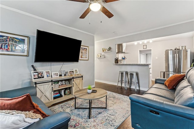 living room with crown molding, ceiling fan, and dark hardwood / wood-style floors