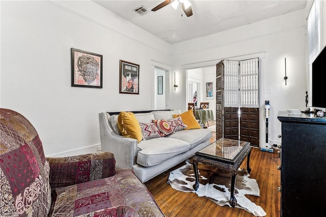 living room with hardwood / wood-style flooring and ceiling fan