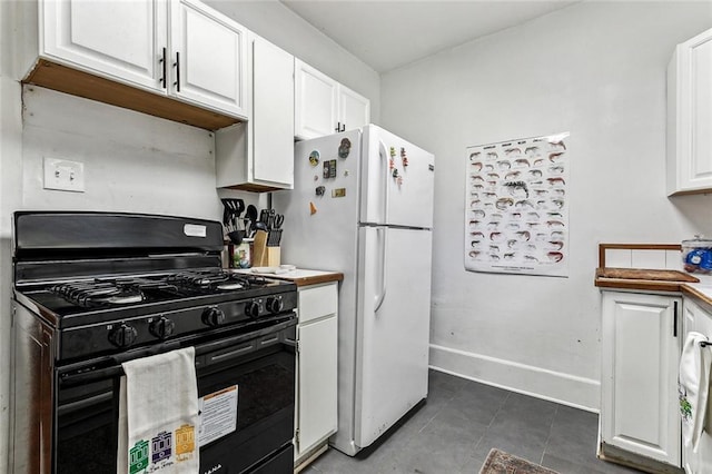 kitchen featuring black gas stove and white cabinets