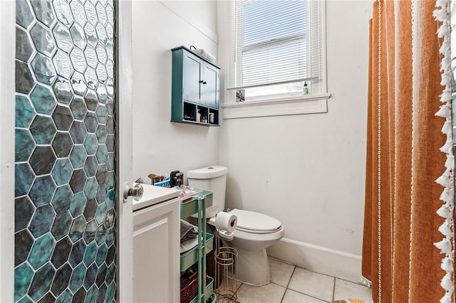 bathroom featuring tile patterned flooring, vanity, and toilet