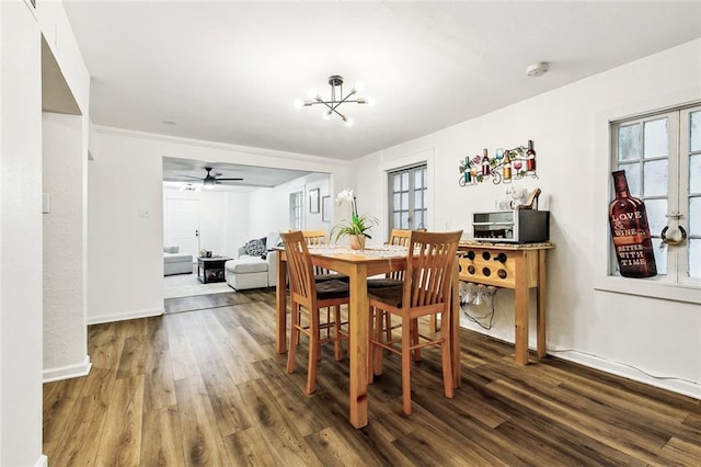 dining space featuring hardwood / wood-style floors and a chandelier