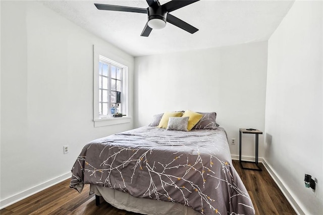 bedroom with ceiling fan and dark hardwood / wood-style flooring