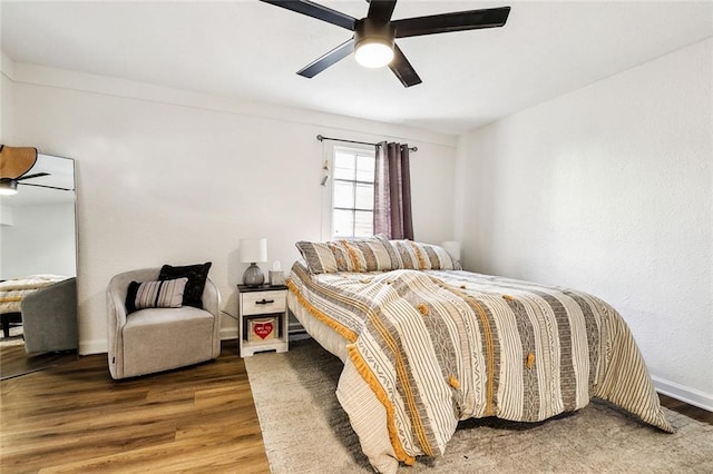 bedroom with hardwood / wood-style floors and ceiling fan