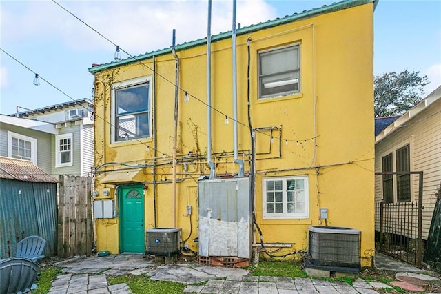 back of property featuring central AC unit