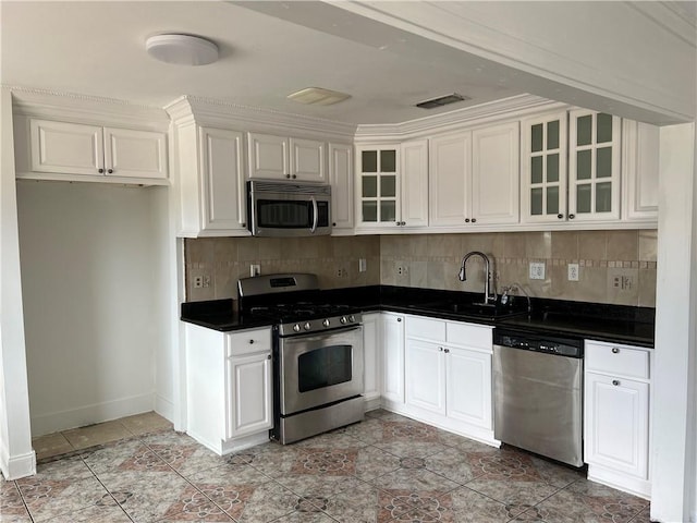 kitchen featuring white cabinetry, appliances with stainless steel finishes, sink, and backsplash