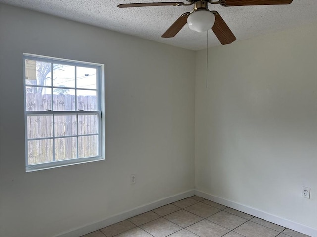 unfurnished room featuring a textured ceiling and light tile patterned floors