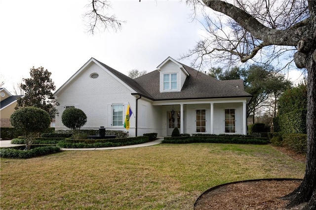 view of front facade featuring covered porch and a front yard