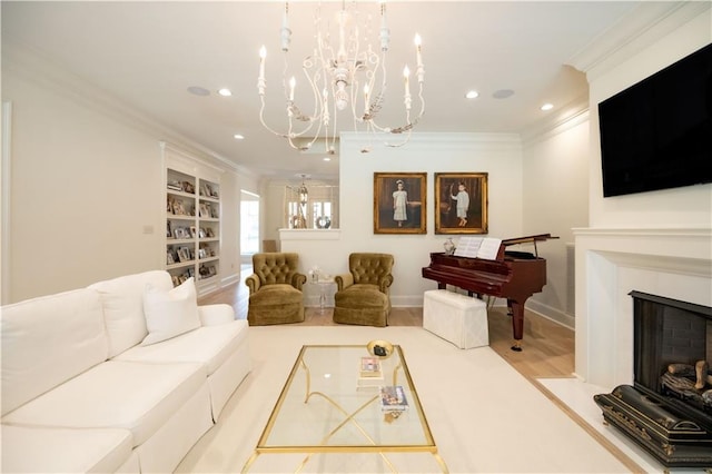 living room with crown molding, light hardwood / wood-style flooring, and built in shelves