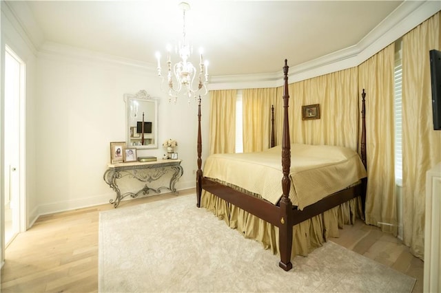 bedroom featuring ornamental molding, a notable chandelier, and light hardwood / wood-style flooring