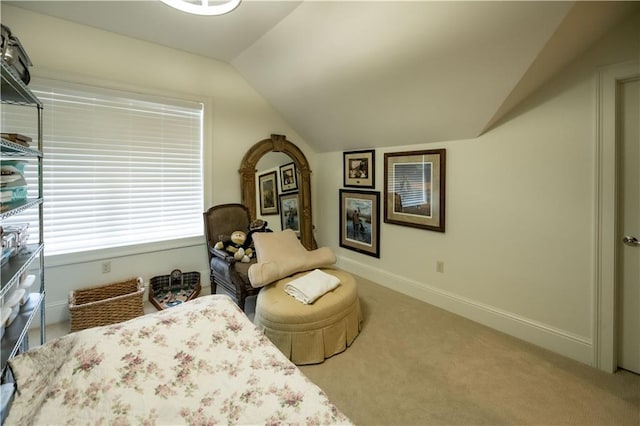 sitting room featuring lofted ceiling and light carpet