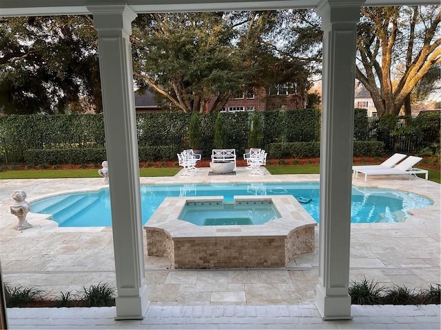 view of swimming pool with a patio area and an in ground hot tub