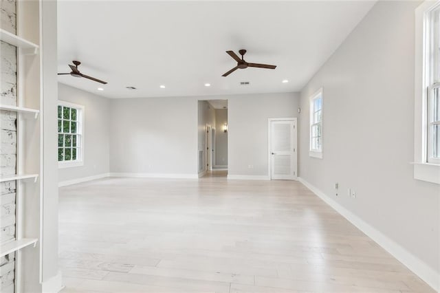 empty room with light hardwood / wood-style flooring and ceiling fan