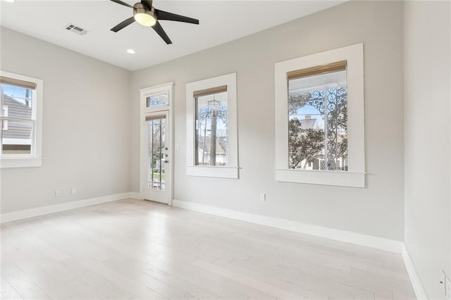 spare room with ceiling fan, light hardwood / wood-style flooring, and a healthy amount of sunlight