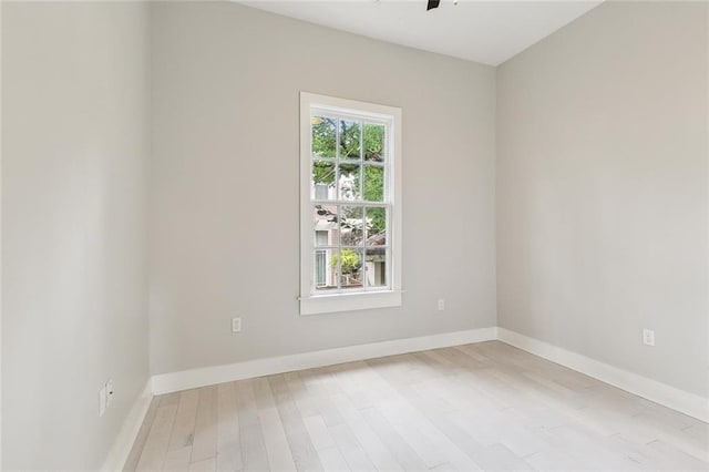 empty room with ceiling fan and light wood-type flooring