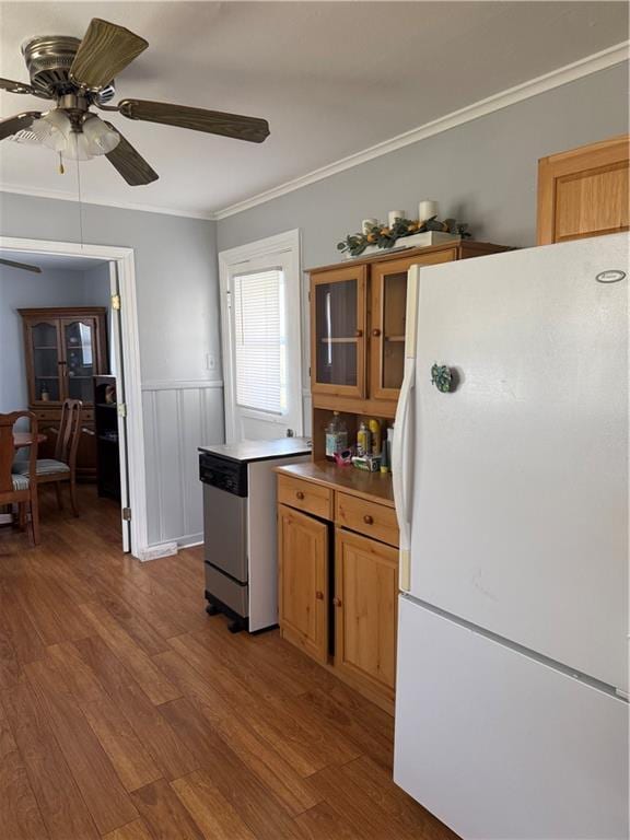 kitchen featuring hardwood / wood-style flooring, ceiling fan, ornamental molding, and white fridge