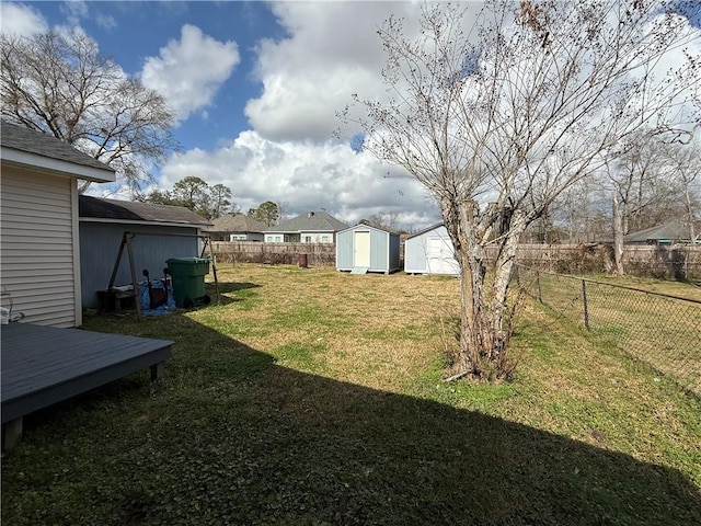 view of yard with a wooden deck and a storage unit